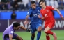 Al Duhail's Adil Boulbina (right) prepares to score a goal against Al Hilal.