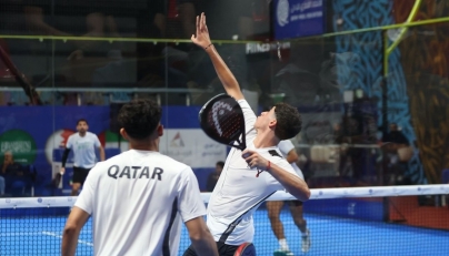 Qatar players in action against Saudi Arabia.