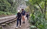 A group of tourists leaves on foot due to a protest by residents in Machu Picchu Pueblo, Peru, on September 16, 2025. (Photo by Carolina Paucar / AFP)
