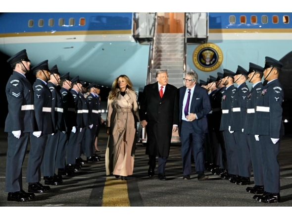 US President Donald Trump (C) and US First Lady Melania Trump disembark from Air Force One after landing at Stansted Airport, eastern England, on September 16, 2025. (Photo by Andrew Caballero-Reynolds / AFP)