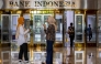 Employees talk in the lobby of Bank Indonesia, the country's central bank, in Jakarta on September 16, 2025. (Photo by Bay Ismoyo / AFP)
