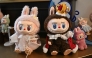 This picture taken on June 18, 2025 shows figures of the characters Mokoko and Labubu in an exhibition room at Pop Mart's theme park Pop Land in Beijing. (Photo by Pedro Pardo / AFP)

