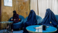 In this photograph taken on August 31, 2025, Afghan burqa-clad women, having appointments for laser treatments, sit in a waiting room at a beauty clinic in Kabul. (Photo by Wakil Kohsar / AFP)