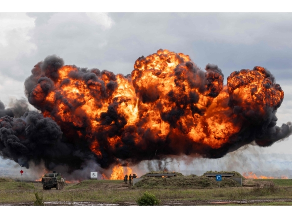 A cloud of smoke and fire rises over the field during military exercises of Poland and NATO allied countries in Orzysz on September 17, 2025. (Photo by Wojtek Radwanski / AFP)

