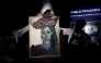 Employees unveal a painting by French artist Pablo Picasso titled 