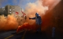A protester lights flares in Marseille, southeastern France, on September 18, 2025, during a day of nationwide strikes and protests called by unions over France's national budget. (Photo by Miguel Medina / AFP)