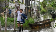 In this photo taken on September 15, 2025, a resident wades through a flooded area in Calumpit, Bulacan. Photo by Jam STA ROSA / AFP