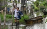 In this photo taken on September 15, 2025, a resident wades through a flooded area in Calumpit, Bulacan. Photo by Jam STA ROSA / AFP