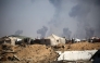 Tents of displaced Palestinians stand in the Nuseirat refugee camp in the central Gaza Strip, as plumes of smoke rise during Israeli bombardment above Gaza City, on September 19, 2025. (Photo by Eyad BABA / AFP)
