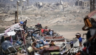 Palestinians from Gaza City move southwards with their belongings, on the coastal road near the Nuseirat refugee camp in the central Gaza Strip, on September 19, 2025. (Photo by Eyad BABA / AFP)
