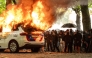 A police car is set on fire during the 