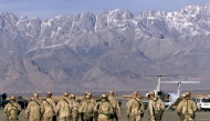(Files) In this file photo taken on January 15, 2002, American soldiers approach the United Nations planes on the tarmac of the Bagram airbase in Bagram. (Photo by Jimin Lai / AFP)