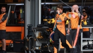 McLaren's Australian driver Oscar Piastri (L) walks in the pits after crashing during a qualifying session of the Formula One Azerbaijan Grand Prix at the Baku City Circuit in Baku on September 20, 2025. (Photo by Anton Vaganov / POOL / AFP)