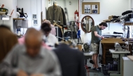 Apprentice tailor Charlie makes adjustments to a jacket at Henry Poole & Co on Savile Row in London on August 12, 2025. (Photo by Henry Nicholls / AFP)