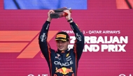 Red Bull Racing's Dutch driver Max Verstappen celebrates with his trophy on the podium after the Formula One Azerbaijan Grand Prix at the Baku City Circuit in Baku on September 21, 2025. (Photo by Alexander NEMENOV / AFP)
