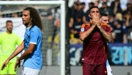 Roma's Italian midfielder #07 Lorenzo Pellegrini celebrates scoring his team's first goal next to Lazio's French midfielder #08 Matteo Guendouzi during the Italian Serie A football match between Lazio and Roma at the Olympic stadium in Rome, on September 21, 2025. (Photo by Tiziana FABI / AFP)