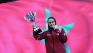 Aya Mohamed celebrates with her trophy and medal.