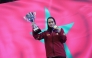 Aya Mohamed celebrates with her trophy and medal.