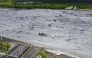 An overview shows flowing mud and floodwaters after a barrier lake burst and caused parts of the bridge over Mataian Creek be destroyed in Hualien on September 24, 2025. (Photo by Taiwan's Central News Agency (CNA) / AFP)