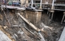A vehicle is seen on the edge of a hole in the ground after a road collapsed near a hospital in Bangkok on September 24, 2025. (Photo by Chanakarn Laosarakham / AFP)