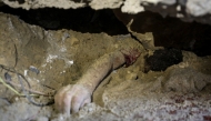 Graphic content: The body of child lies buried under the rubble of a building hit by an Israeli strike in the Nuseirat refugee camp in the central Gaza Strip, on September 25, 2025, as Israel presses its air and ground offensive to capture the nearby Gaza City. (Photo by Eyad BABA / AFP)
