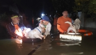 :In this handout photo taken early September 26, 2025 and released by the Philippine Coast Guard (PCG), coast guard personnel evacuate residents along with their pets at the height of Severe Tropical Storm Bualoi in Ormoc City, Leyte province, central Philippines. (Photo by Handout / Philippine Coast Guard (PCG) / AFP)
