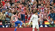 Atletico Madrid's Argentine forward #19 Julian Alvarez celebrates with supporters scoring his team's fourth goal in spite of Real Madrid's Belgian goalkeeper #01 Thibaut Courtois during the Spanish league football match between Club Atletico de Madrid and Real Madrid CF at the Metropolitano stadium in Madrid on September 27, 2025. (Photo by Javier SORIANO / AFP)
