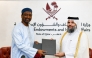 Undersecretary of the Ministry of Awqaf and Islamic Affairs H E Dr. Sheikh Khalid bin Mohammed bin Ghanem Al Thani (right) and IIFA Secretary-General H E Prof. Dr. Koutoub Mustapha Sano exchanging documents after signing the MoU.