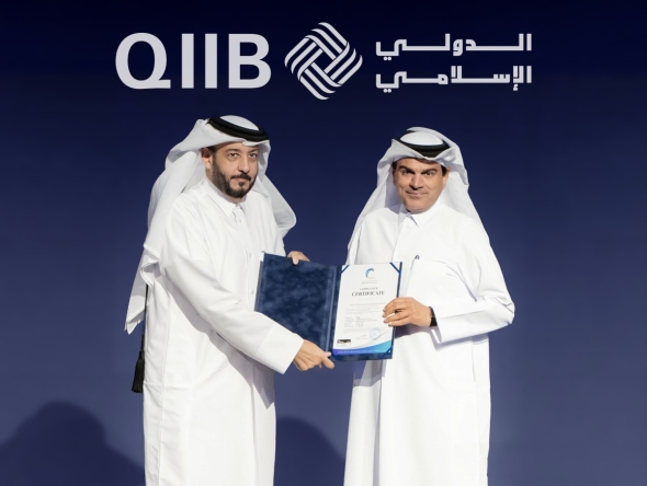 NCSA President Eng. Abdul Rahman Ali Muhammad Al-Farahid Al-Malki presenting the NIA certification to QIIB Chief Executive Officer, Dr. Abdulbasit Ahmad al-Shaibei.