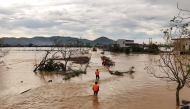 An aerial photo shows rescue workers walking through flood waters after typhoon Bualoi passed over Lam Thanh commune in Nghe An province on September 30, 2025. (Photo by Phan Duy / AFP)