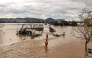 An aerial photo shows rescue workers walking through flood waters after typhoon Bualoi passed over Lam Thanh commune in Nghe An province on September 30, 2025. (Photo by Phan Duy / AFP)