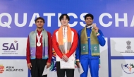 Qatar's Ali Tamer (left) celebrates on the podium with gold winner Wang of China and India’s Srihari Natraj who won the bronze, in the 100m freestyle event. 