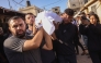 Palestinians carry the body of a man killed in an Israeli strike, during a funeral procession outside al-Aqsa Martyrs hospital in Deir el-Balah in the central Gaza Strip, on October 1, 2025. (Photo by BASHAR TALEB / AFP)
