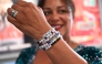 A fan shows her bracelet spelling out song titles written by Taylor Swift as they attend 