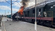 This handout photograph, taken and released by the press service of Ukrainian Railways on October 4, 2025, shows a burning train carriage following a drone attack in Shostka, Sumy region, amid the Russian invasion of Ukraine.(Photo by Handout / UKRAINIAN RAILWAYS / AFP) 