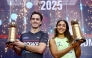 New Zealand’s Paul Coll and Egypt’s Hania El Hammamy celebrate with their trophies.