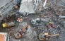 An aerial view shows rescuers searching for victims at the Al Khoziny Islamic boarding school in Sidoarjo, East Java, on October 5, 2025, after a multi-story building at the school collapsed during prayers. (Photo by Dicky Bisinglasi / AFP)