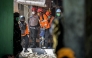 Rescuers search for victims at the Al Khoziny Islamic boarding school in Sidoarjo, East Java, on October 5, 2025, after a multi-storey building at the school collapsed. (Photo by JUNI KRISWANTO / AFP)
