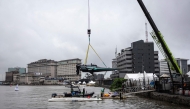 Team Drogba's E1 race boat is lowered into the Lagos Lagoon before racing in Lagos, on October 05, 2025. (Photo by OLYMPIA DE MAISMONT / AFP)
