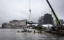 Team Drogba's E1 race boat is lowered into the Lagos Lagoon before racing in Lagos, on October 05, 2025. (Photo by OLYMPIA DE MAISMONT / AFP)