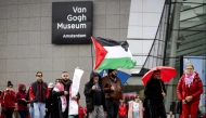 Demonstrators including one with a Palestinian flag gather at Museumplein for a 