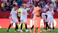 Barcelona's Spanish defender #03 Alex Balde reacts to Sevilla's third goal scored by Spanish defender #02 Jose Angel Carmona during the Spanish league football match between Sevilla FC and FC Barcelona at Ramon Sanchez Pizjuan Stadium in Seville on October 5, 2025. (Photo by CRISTINA QUICLER / AFP)
