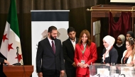Syria's interim President Ahmed al-Sharaa (left) visits the poling station where members of Syrian local committees have been casting their votes in the country's selection process to designate an interim parliament, in Damascus on October 5, 2025. (Photo by Louai Beshara / AFP)
