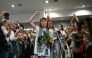 Swedish climate campaigner Greta Thunberg raises her fist, upon arrival alongside activists who were sailing aboard vessels from the Gaza-bound aid flotilla before being stopped and detained by Israeli forces, greeted by a crowd of supporters, at the arrivals area of Athens International Airport on October 6, 2025. (Photo by Aris Messinis / AFP)