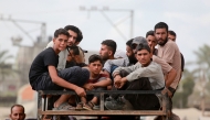 Displaced Palestinians ride a vehicle south of Deir El-Balah in the Central Gaza Strip yesterday.  ( AFP)