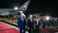 In this pool photograph distributed by the Russian state agency Sputnik, Russia's President Vladimir Putin (right) walks with his Tajik counterpart Emomali Rakhmon upon the Russian leader's arrival at the airport in Dushanbe on October 8, 2025. (Photo by Kristina Kormilitsyna / POOL / AFP)
