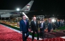 In this pool photograph distributed by the Russian state agency Sputnik, Russia's President Vladimir Putin (right) walks with his Tajik counterpart Emomali Rakhmon upon the Russian leader's arrival at the airport in Dushanbe on October 8, 2025. (Photo by Kristina Kormilitsyna / POOL / AFP)
