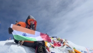Safrina Latheef holding India and Qatar flags atop Mount Everest on May 18, 2025.