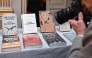 A photographer takes photos of Books of Hungarian writer Laszlo Krasznahorkai, the winner of the 2025 Nobel Prize in Literature, on display at the Swedish Academy in Stockholm, Sweden, on October 9, 2025. (Photo by Jonathan Nackstrand / AFP) 