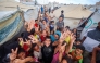 Palestinian children celebrate at a camp for displaced people in Nuseirat in the central Gaza Strip on October 9, 2025, following news of a new peace deal. (Photo by Eyad Baba / AFP)
